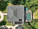 Aerial view of home featuring a backyard pool with screened enclosure at 9175 Se 7Th Avenue Rd, Ocala, FL 34480