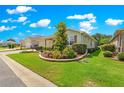Landscaped front yard with mature trees, shrubs, and retaining wall, offering great curb appeal at 9203 Sw 97Th Cir, Ocala, FL 34481