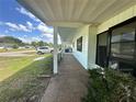 Covered porch, perfect for enjoying the outdoors, and parking space with an electric vehicle charger at 10080 Sw 97Th Ct, Ocala, FL 34481