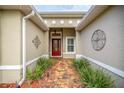 Charming entryway with decorative sidelights surrounding the front door at 10279 Julia Isles Ave, Oxford, FL 34484
