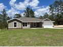 A charming single-story home with neutral paint, stone accents, and a well-manicured lawn at 12505 Sw 73Rd St, Ocala, FL 34481