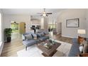 Bright living room featuring stylish furniture, modern decor, and wood-look floors at 12505 Sw 73Rd St, Ocala, FL 34481
