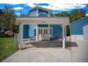 Charming home entrance with double doors under a covered porch and a matching garage nearby at 12690 Ne Highway 315, Fort Mc Coy, FL 32134