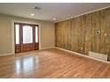 Bright living room featuring wood floors, a decorative wood wall, and recessed lighting at 1610 Se 22Nd Ave, Ocala, FL 34471