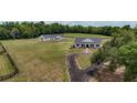 Scenic ranch estate with a private drive, fenced acreage, a white farmhouse, and a secondary building at 1631 W Hwy 329, Citra, FL 32113