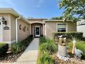Close up shot of the front entrance featuring a decorative security door, garden and walkway at 16405 Sw 14Th Avenue Rd, Ocala, FL 34473