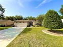 Inviting single-story home with a well-maintained lawn, mature landscaping, and a two-car garage at 16405 Sw 14Th Avenue Rd, Ocala, FL 34473