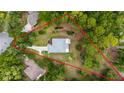 A lovely aerial view of a home with wooded lot outlined in red at 19028 Sw 101 Pl, Dunnellon, FL 34432