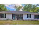 Inviting front yard with cozy chairs, decorative flowers, and charming touches, showcasing the home's curb appeal at 19370 Saint Benedict Dr, Dunnellon, FL 34432