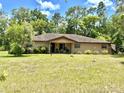 Charming single-story home with a covered front porch and large yard at 20100 Sw 95 St, Dunnellon, FL 34431