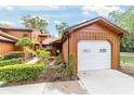 Charming exterior view of home, featuring a one car garage and well maintained landscaping at 2701 Ne 10Th St # 101, Ocala, FL 34470