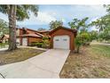Charming exterior view of home, featuring garages and manicured landscaping at 2701 Ne 10Th St # 101, Ocala, FL 34470