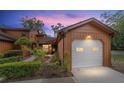 Charming exterior view of home at dusk, featuring a one car garage and landscaping at 2701 Ne 10Th St # 101, Ocala, FL 34470