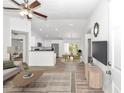 Bright living space with vaulted ceilings, light wood floors, flows into an open kitchen and dining area at 3270 Sw 151St Ct, Ocala, FL 34481