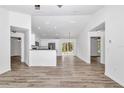 Spacious open floorplan with vaulted ceilings and hardwood floors leads to a kitchen with stainless appliances at 3270 Sw 151St Ct, Ocala, FL 34481