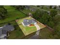 Aerial shot of a charming single-story home with spacious yard, fenced perimeter, and tree-lined property borders at 380 Ne 53Rd St, Ocala, FL 34479