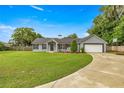 Inviting single-story residence with a well-maintained lawn, attached garage, and a traditional architectural style at 380 Ne 53Rd St, Ocala, FL 34479