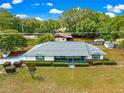 An aerial view showcases this home's location and landscaped front yard and quaint blue porch at 4880 Ne 23 Ave, Ocala, FL 34479