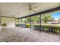 The covered front porch features a decorative concrete floor, ceiling fans, and shade at 4880 Ne 23 Ave, Ocala, FL 34479