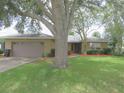 Well-maintained single-story home featuring a manicured lawn, inviting entrance, and an attached garage at 5083 Se 26Th St, Ocala, FL 34480