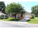 Charming single-story home with a well-manicured lawn and an attached garage at 5110 Nw 19Th Pl, Ocala, FL 34482