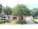 Charming single-story home with an attached garage and a well-manicured lawn at 5110 Nw 19Th Pl, Ocala, FL 34482