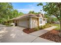 Exterior side view of house featuring a driveway, garage, and partial landscaping at 5174 Se 41St Ave, Ocala, FL 34480