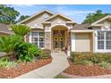 Inviting front entrance with double doors, stone accents, and well-maintained landscaping at 5174 Se 41St Ave, Ocala, FL 34480
