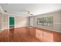 Spacious living room featuring hardwood floors and a large window for natural light at 5720 Se 20Th St, Ocala, FL 34480