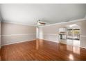 Spacious living room with hardwood floors, and access to the kitchen and pool area at 5720 Se 20Th St, Ocala, FL 34480