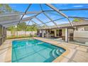Inviting screened-in pool area with outdoor seating, perfect for relaxing and entertaining at 5720 Se 20Th St, Ocala, FL 34480