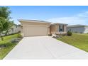 Well-maintained single-story home with a manicured lawn and landscaped garden, as well as an attached two car garage at 5842 Sw 78Th Avenue Rd, Ocala, FL 34474