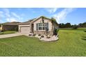 Attractive single-story home with stone accents, blue shutters, and a lush green lawn at 6405 Sw 88Th Loop, Ocala, FL 34476