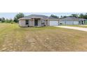 A cozy single-story home featuring a well-maintained lawn and driveway at 6561 Sw 129Th Loop, Ocala, FL 34473
