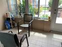 Relaxing patio area featuring comfortable seating, tile flooring, and natural light streaming through the windows at 7251 Sw 115Th Pl, Ocala, FL 34476