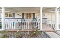 Inviting front porch featuring comfortable seating and decorative accents for relaxation at 8420 Sw 93 Ln # E, Ocala, FL 34476