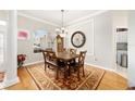 Elegant dining room featuring a wood table, six chairs, a rug, and a large window at 8737 Sw 83Rd Cir, Ocala, FL 34481
