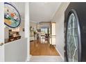 Inviting entryway with hardwood floors, columns, and an oval glass window in the front door at 8737 Sw 83Rd Cir, Ocala, FL 34481