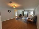 Open-concept living room with hardwood floors and neutral walls at 8801 Sw 92Nd St # B, Ocala, FL 34481