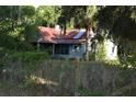 Quaint cottage-style home with mature trees and landscaping, needs renovation at 1050 E Highway 329, Citra, FL 32113