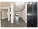 Open concept home showcases wood-look tile flooring and a glimpse into the spacious living areas at 10910 Sw 41St Ave, Ocala, FL 34476