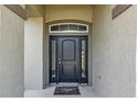 Welcoming front door with sidelights and a transom window, providing natural light to the entry at 10910 Sw 41St Ave, Ocala, FL 34476