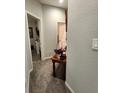 Hallway with neutral carpet, textured walls, and a glimpse into the adjacent rooms adds depth at 11412 Sw 51St Cir, Ocala, FL 34476
