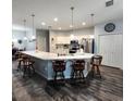 Bright kitchen featuring an extended breakfast bar, stainless appliances, and modern pendant lighting at 11412 Sw 51St Cir, Ocala, FL 34476