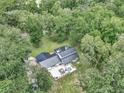 Aerial view of the property showcasing the home's layout and lush surroundings at 12677 Se 53Rd Terrace Rd, Belleview, FL 34420