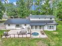 Backyard patio with a hot tub and space for outdoor entertaining at 12677 Se 53Rd Terrace Rd, Belleview, FL 34420