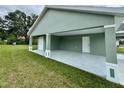 View of the large covered parking area, with side door access to the home at 13319 Sw 106Th Pl, Dunnellon, FL 34432
