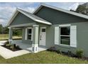 Inviting home exterior with a neatly landscaped front yard, showcasing the entrance and windows at 13319 Sw 106Th Pl, Dunnellon, FL 34432