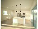 Bright kitchen with a center island, stainless steel appliances, and sliding glass doors at 15215 Sw 43Rd Ct, Ocala, FL 34473