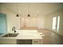 Open living room showcasing sleek light wood floors and minimalist design at 15215 Sw 43Rd Ct, Ocala, FL 34473